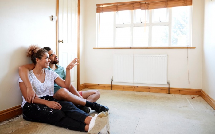 couple sitting on the floor in their newly painted room
