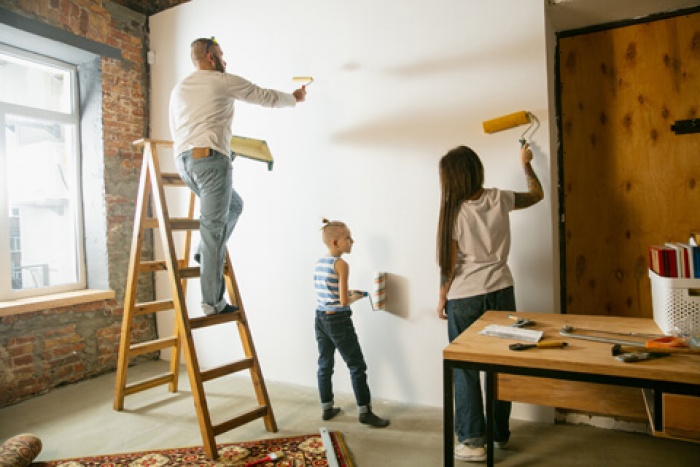 a family works together on DIY painting and other home renovations