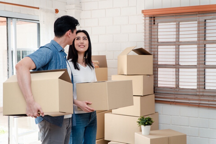first-time home buyers moving boxes in their new home