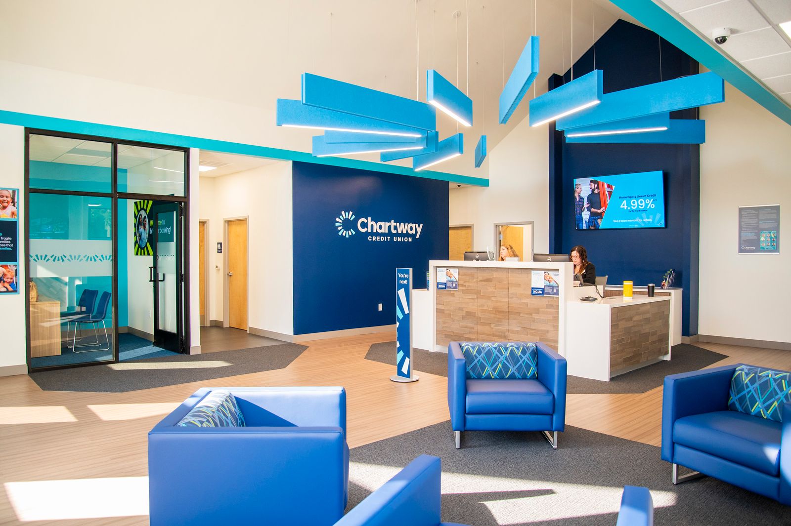 Picture of Chartway Credit Union's interior with blue chairs and blue light fixtures